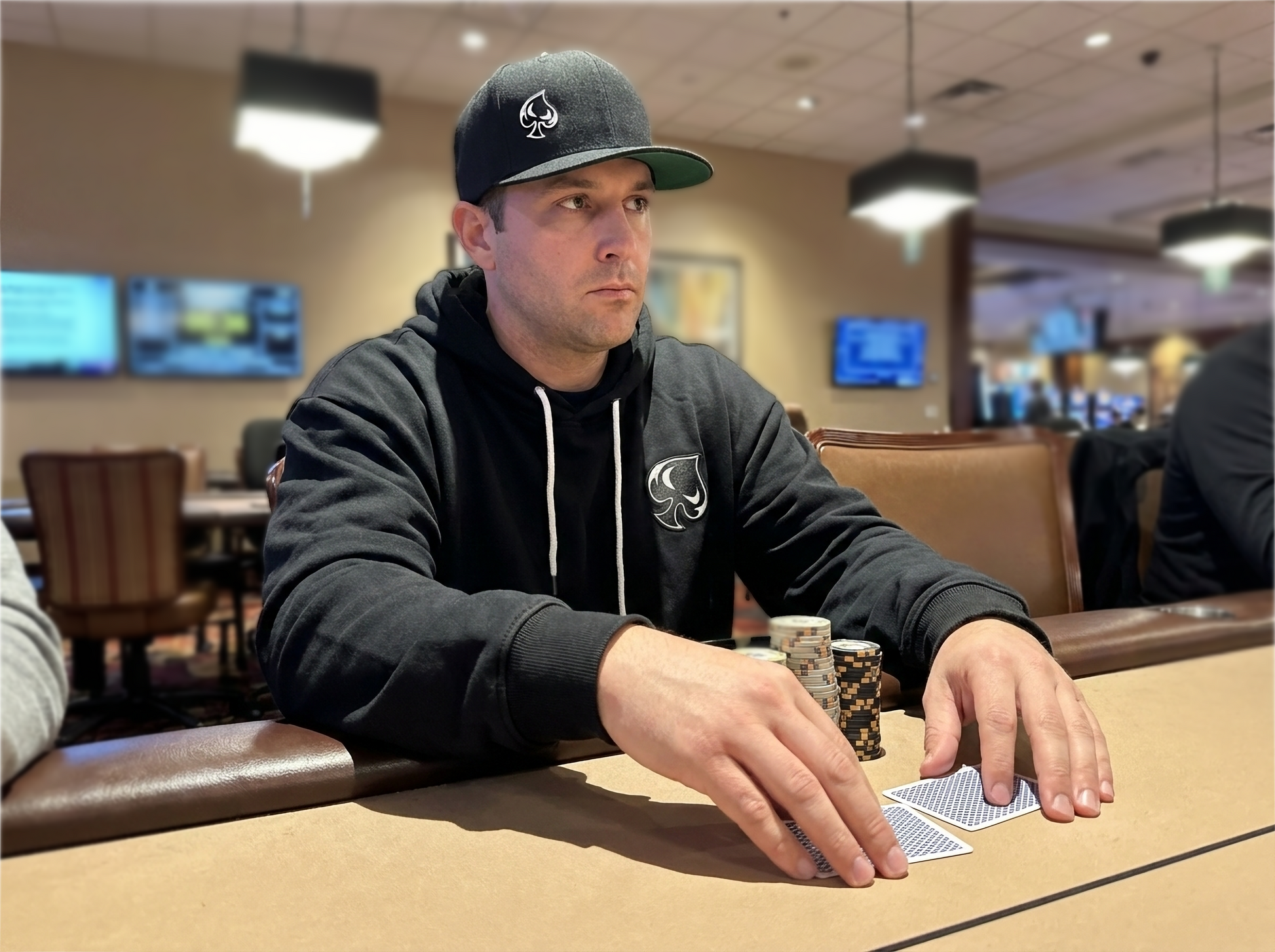 AI generated picture of a man wearing a hoodie in a cardroom