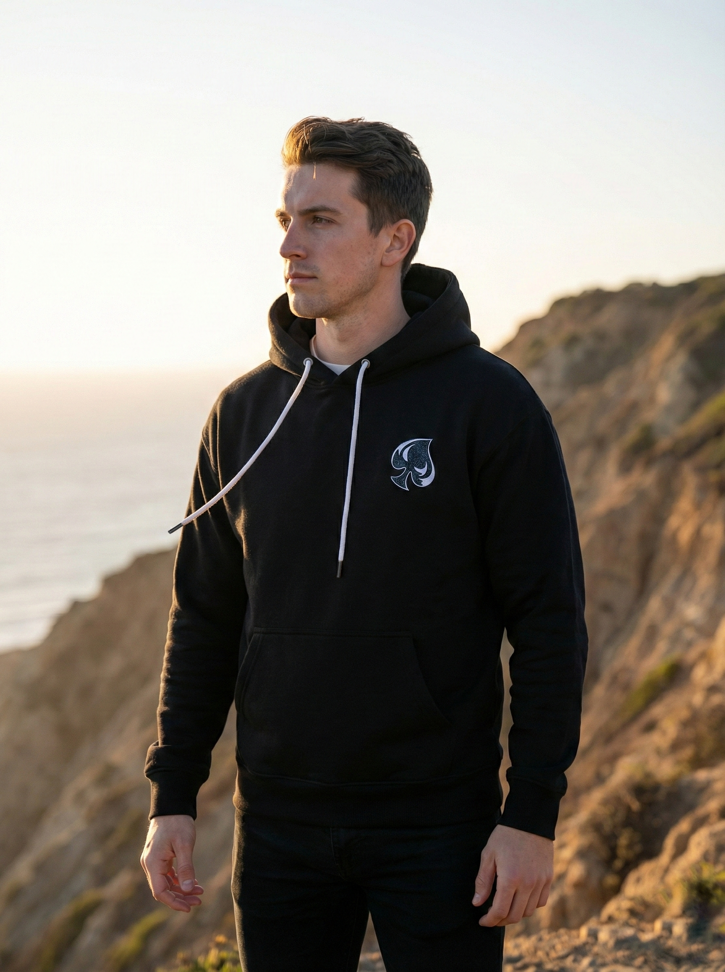 AI generated picture of a man wearing a hoodie next to a cliff