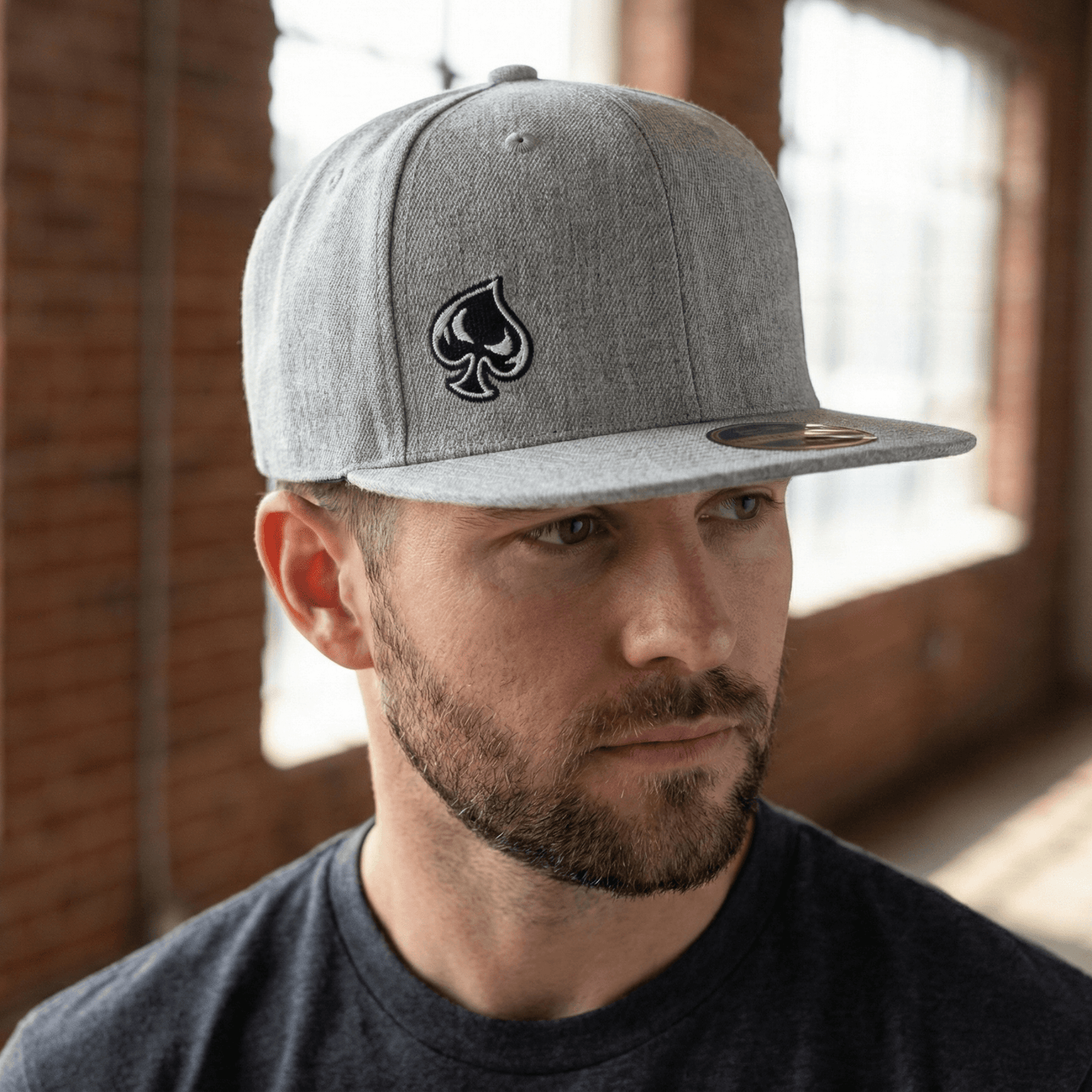 Ai generated picture of a man wearing a heather gray hat with a spade logo